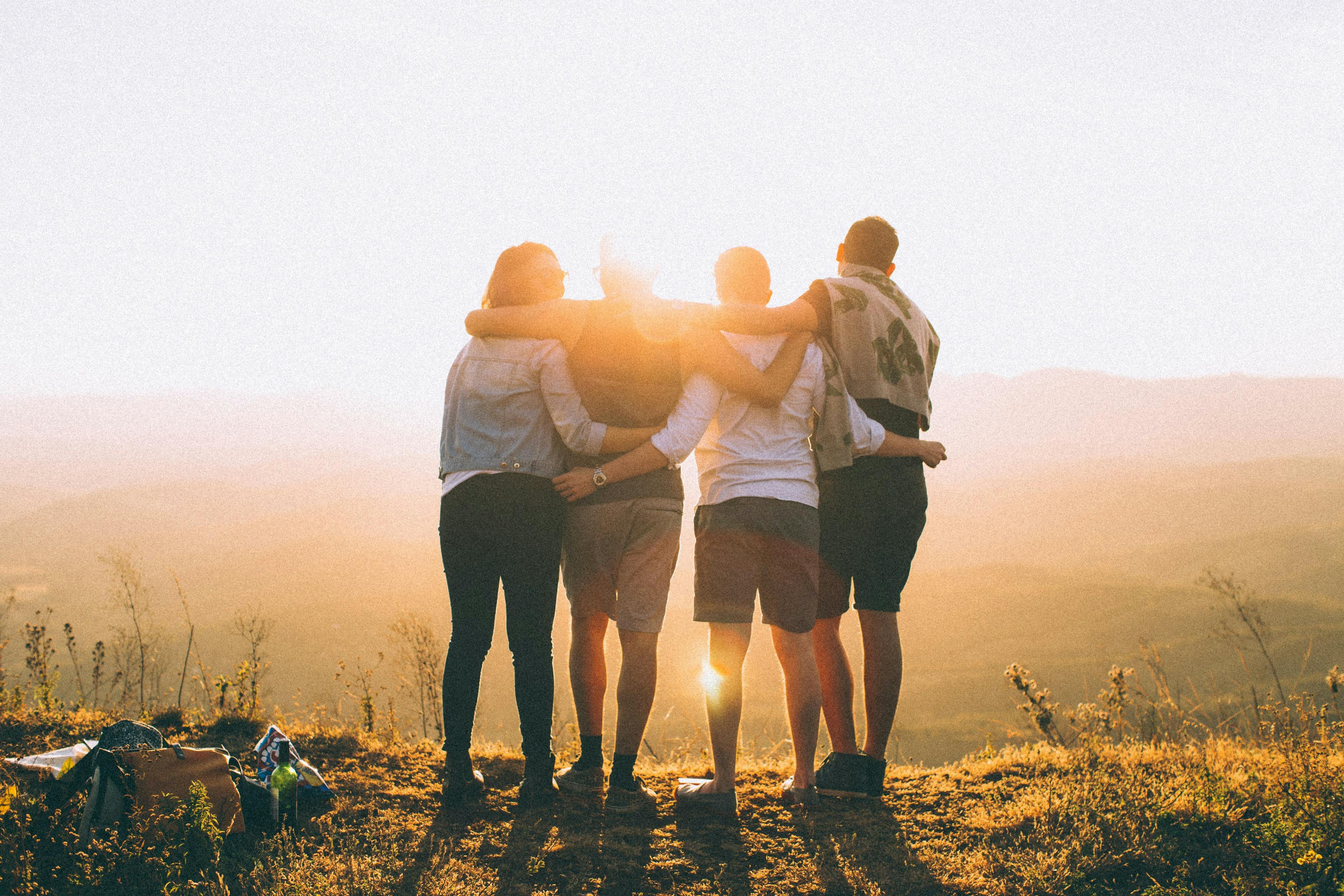 Group of friends looking into sunset